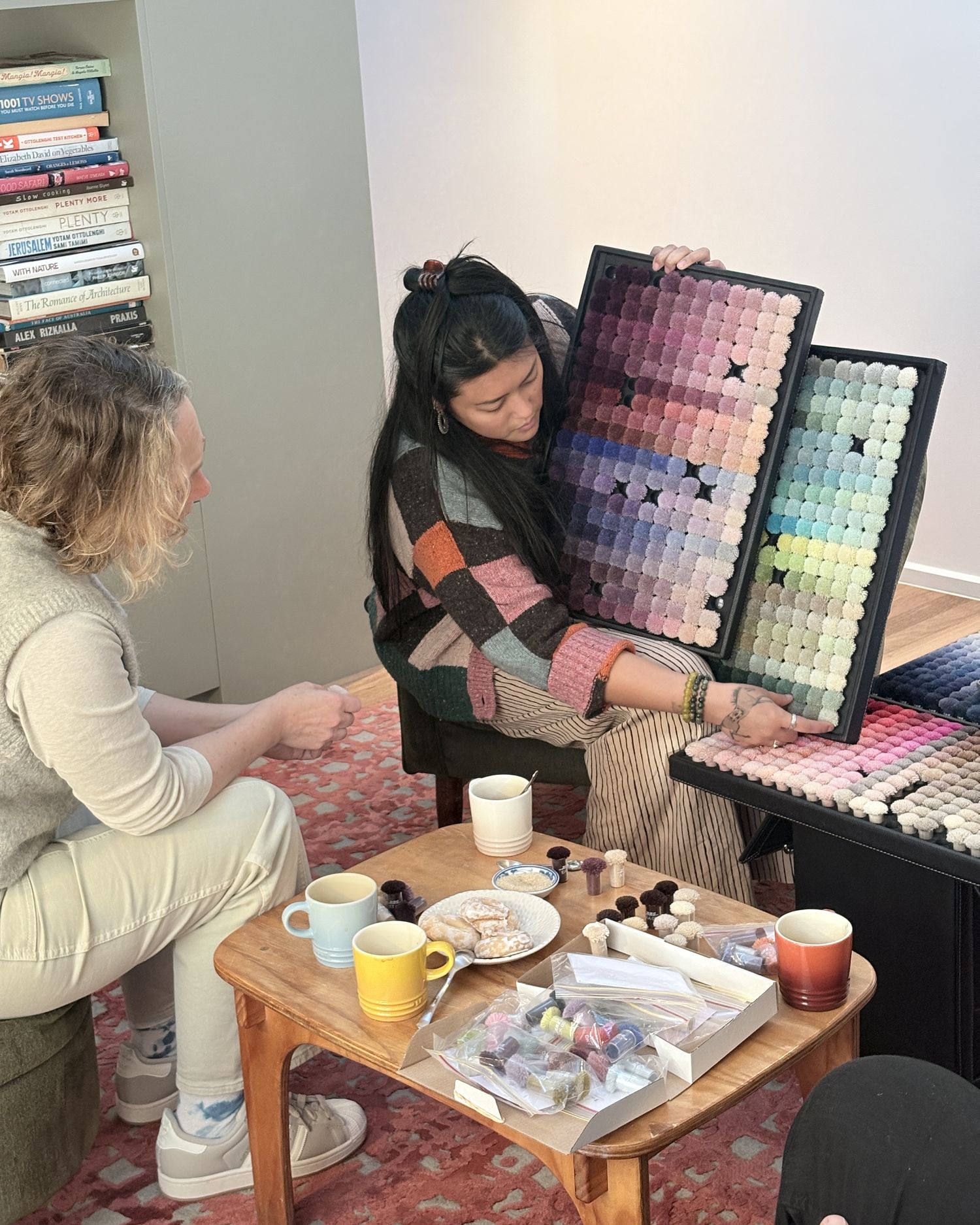 Choosing wool colours from the pom-pom trays during a studio appointment